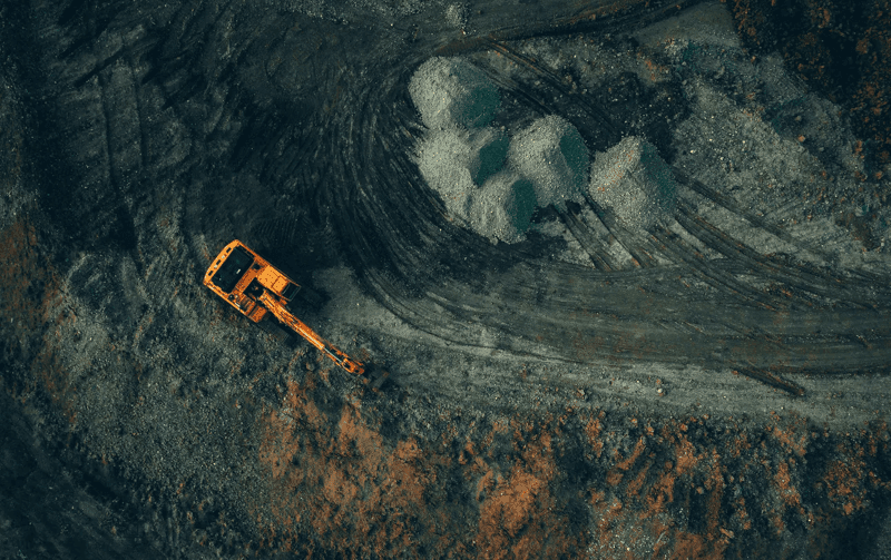 Excavator on dark mining background 
