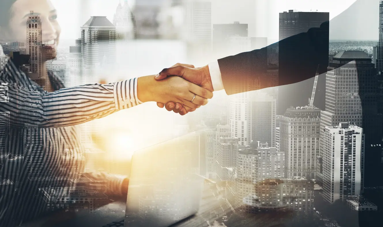 Two businesspeople shaking hands during a deal