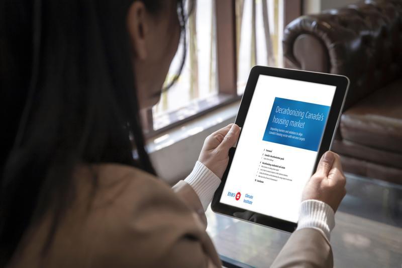 2 men and one woman looking at tablet screen